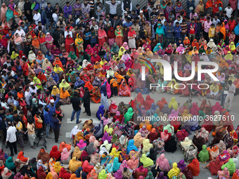 Bangladeshi garment workers block a road during a demonstration to demand higher wages, in Dhaka on January 9, 2019.  (