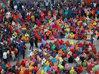 Bangladeshi garment workers block a road during a demonstration to demand higher wages, in Dhaka on January 9, 2019.  (