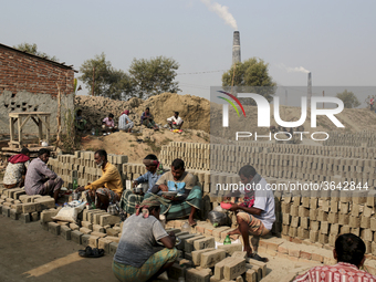 Brick field workers are eating lunch after his work shift in brickfields Narayanganj near Dhaka Bangladesh on January 12, 2019 (