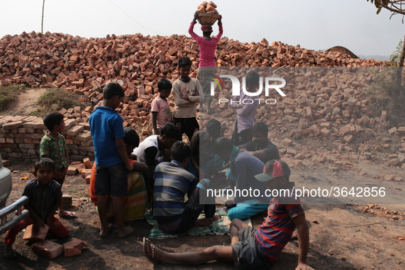 Brick field workers are eating lunch after his work shift in brickfields Narayanganj near Dhaka Bangladesh on January 12, 2019. 