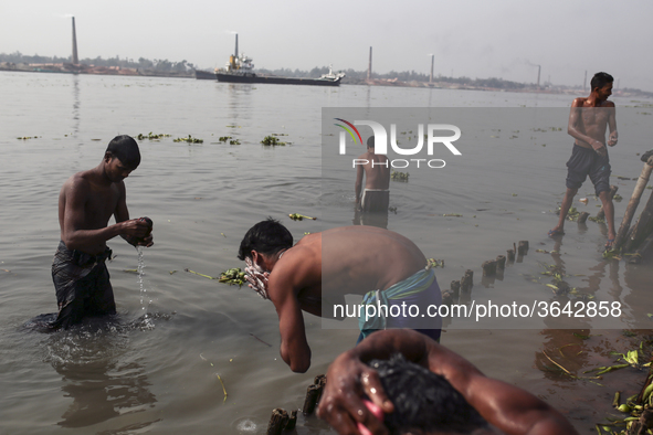 Brick field worker are having bath after his work shift in brickfields Narayanganj near Dhaka Bangladesh on January 12, 2019. 