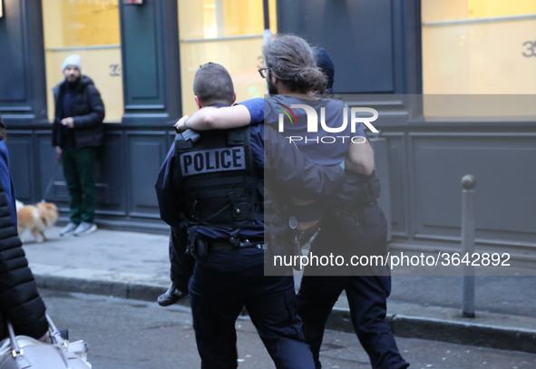 An injured man is treated by policemen after the explosion of a bakery on the corner of the streets Saint-Cecile and Rue de Trevise in centr...