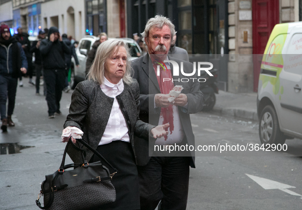 Injured people are seen after the explosion of a bakery on the corner of the streets Saint-Cecile and Rue de Trevise in central Paris on Jan...