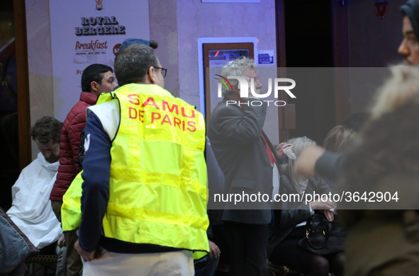 An injured man is treated by emergency workers after the explosion of a bakery on the corner of the streets Saint-Cecile and Rue de Trevise...