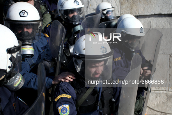 Riot police officer without tear gas mask while spraying protesters during a protest outside the Greek Parliament in Athens, Greece on Janua...