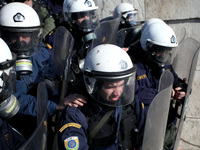 Riot police officer without tear gas mask while spraying protesters during a protest outside the Greek Parliament in Athens, Greece on Janua...