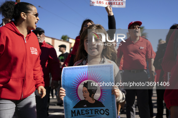 A child and striking teachers with the Los Angeles Unified School District march in a parade honoring Dr. Martin Luther King, Jr. in Los Ang...