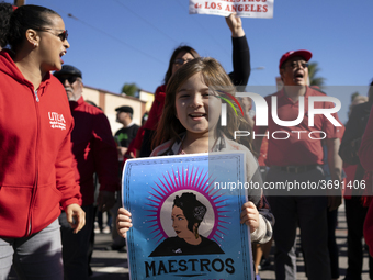 A child and striking teachers with the Los Angeles Unified School District march in a parade honoring Dr. Martin Luther King, Jr. in Los Ang...