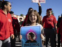 A child and striking teachers with the Los Angeles Unified School District march in a parade honoring Dr. Martin Luther King, Jr. in Los Ang...