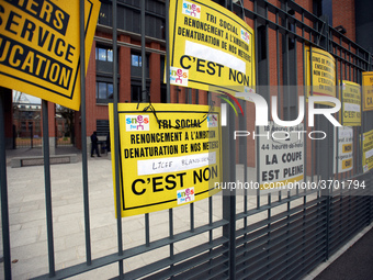 Demonstrators put placards on the metal gates of the Local board of Education of Toulouse. Several schoolteachers unions and two students un...