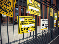 Demonstrators put placards on the metal gates of the Local board of Education of Toulouse. Several schoolteachers unions and two students un...