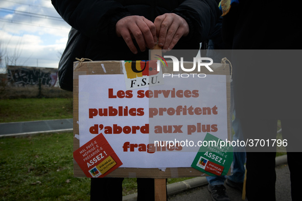 A man holds a placard reading 'Public services are first good for the most precarious'. Several schoolteachers unions and two students union...