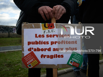 A man holds a placard reading 'Public services are first good for the most precarious'. Several schoolteachers unions and two students union...