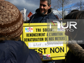 A man holds a placard reading 'Social selecting, ambition renunciation, Blanquer highschool, it's NO !'.  Several schoolteachers unions and...