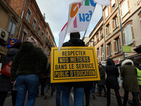 A teacher has a placard on his back reading 'Respect our jobs in the Public Service of Education'. Several schoolteachers unions and two stu...