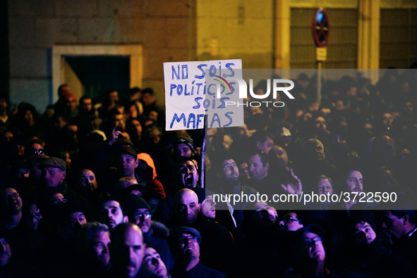 Taxi drivers hold placards `You are not politicians, are a mafia (mob)´ and chant slogans during the demonstration against Uber and Cabify i...