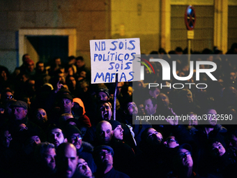 Taxi drivers hold placards `You are not politicians, are a mafia (mob)´ and chant slogans during the demonstration against Uber and Cabify i...