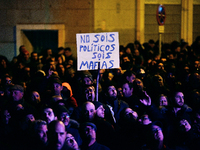 Taxi drivers hold placards `You are not politicians, are a mafia (mob)´ and chant slogans during the demonstration against Uber and Cabify i...