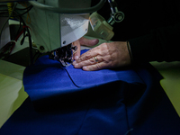 A person works inside a Neapolitan tailoring factory in Naples, Italy, on January 30, 2019 (