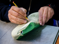 A person works inside a Neapolitan tailoring factory in Naples, Italy, on January 30, 2019 (