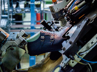 A person works inside a Neapolitan tailoring factory in Naples, Italy, on January 30, 2019 (