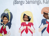 Students take pictures on a vehicle playing in the Back to School Campaign held by the Sayangi Tunas Cilik Foundation (STC) at Vatulemo Fiel...