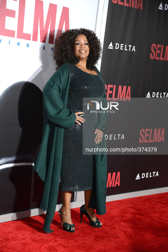 Oprah Winfrey in Giorgio Armani green sequin dress attends the New York Premiere of "Selma" on December 14, 2014 at the Ziegfeld Theatre in...