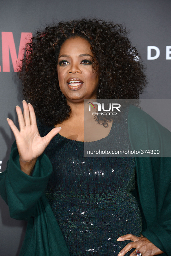 Oprah Winfrey in Giorgio Armani green sequin dress attends the New York Premiere of "Selma" on December 14, 2014 at the Ziegfeld Theatre in...