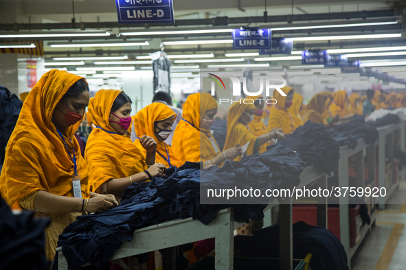 Workers at a garment factory work at MB Knit garment factory in Narayanganj, near Dhaka. 