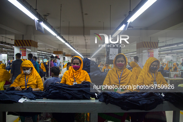 Workers at a garment factory work at MB Knit garment factory in Narayanganj, near Dhaka. 