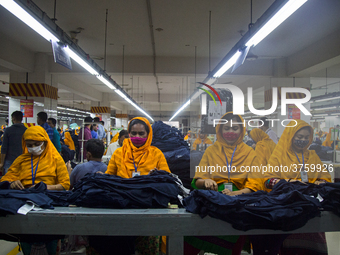 Workers at a garment factory work at MB Knit garment factory in Narayanganj, near Dhaka. (