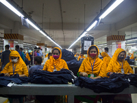 Workers at a garment factory work at MB Knit garment factory in Narayanganj, near Dhaka. (