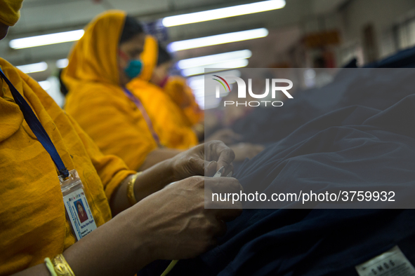 Workers at a garment factory work at MB Knit garment factory in Narayanganj, near Dhaka. 