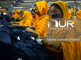 Workers at a garment factory work at MB Knit garment factory in Narayanganj, near Dhaka. (