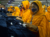 Workers at a garment factory work at MB Knit garment factory in Narayanganj, near Dhaka. (