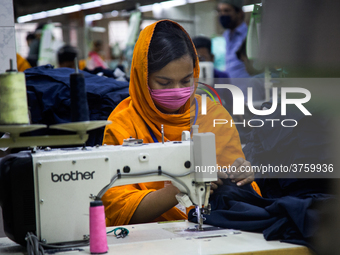 Workers at a garment factory work at MB Knit garment factory in Narayanganj, near Dhaka. (