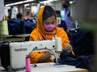 Workers at a garment factory work at MB Knit garment factory in Narayanganj, near Dhaka. (