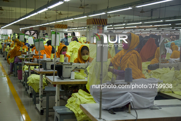 Workers at a garment factory work at MB Knit garment factory in Narayanganj, near Dhaka. 