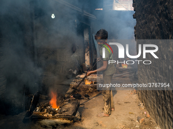 Shihab (8) works in a metal shop near shipyard where he breaks metal small pieces and puts them into the furnace. Dhaka, Bangladesh, Februar...