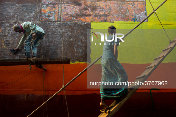 Shipyard workers are painting a newly made ship in Dhaka. Workers work here without minimum safety guard. Conditions are hot and often dange...