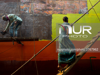 Shipyard workers are painting a newly made ship in Dhaka. Workers work here without minimum safety guard. Conditions are hot and often dange...