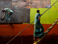 Shipyard workers are painting a newly made ship in Dhaka. Workers work here without minimum safety guard. Conditions are hot and often dange...