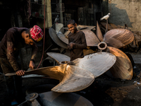 A child worker laughs with his supervisor in a metal workshop near Dhaka Shipyard, Bangladesh, February 7, 2019 (