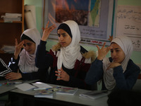 Deaf Palestinian students in Gaza get lessons in their classroom at first school in Palestine care with them, on 10 February 2019. (