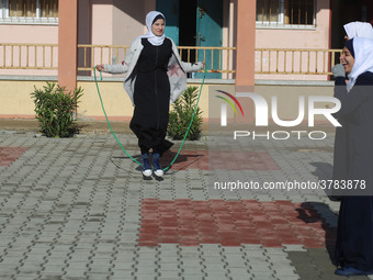 Deaf Palestinian students play in the school yard at first school in Palestine care with them, on 10 February 2019. (