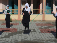 Deaf Palestinian students play in the school yard at first school in Palestine care with them, on 10 February 2019. (