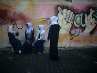 Deaf Palestinian students the school yard at first school in Palestine care with them, on 10 February 2019. (