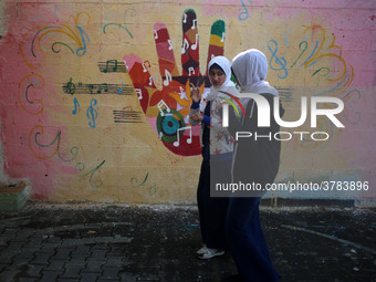 Deaf Palestinian students the school yard at first school in Palestine care with them, on 10 February 2019. (