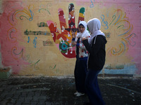 Deaf Palestinian students the school yard at first school in Palestine care with them, on 10 February 2019. (