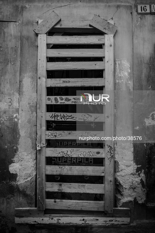 A door of shoop in the historic center of L'Aquila City, on January 11, 2014, severely damaged after the earthquake of April 6, 2009. 